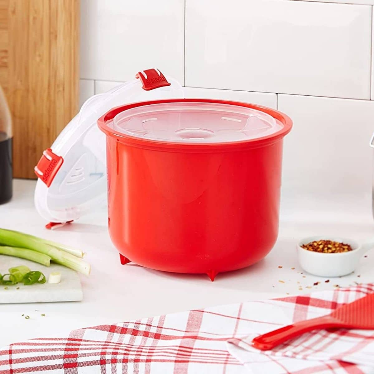 Red microwave rice cooker on kitchen table.