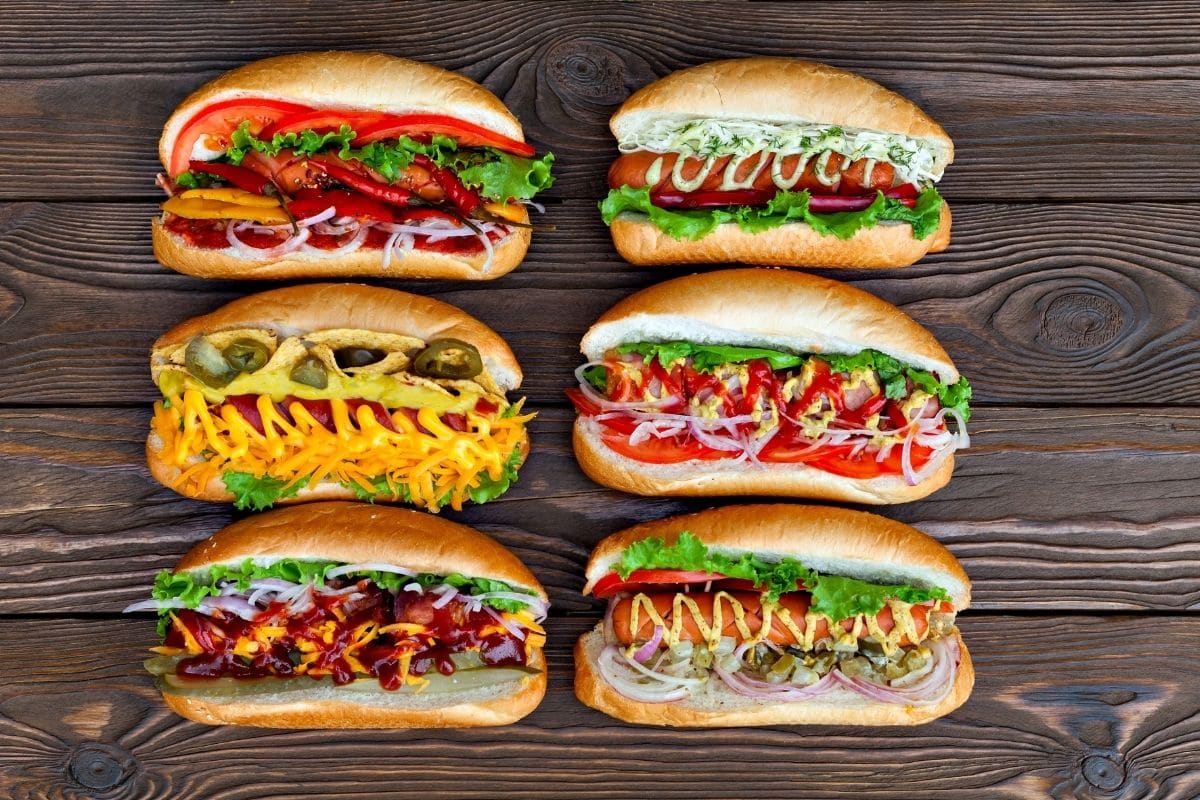 Delicious homemade hot dogs with vegetables  on wooden table.
