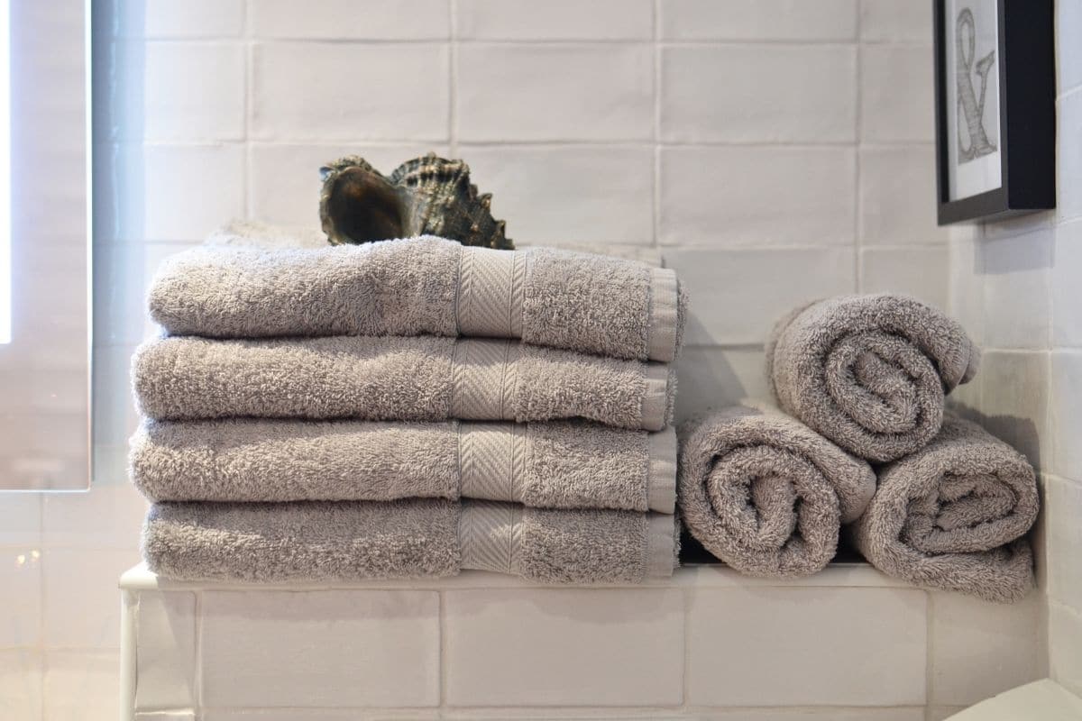 Stack of gray towels in bathroom.