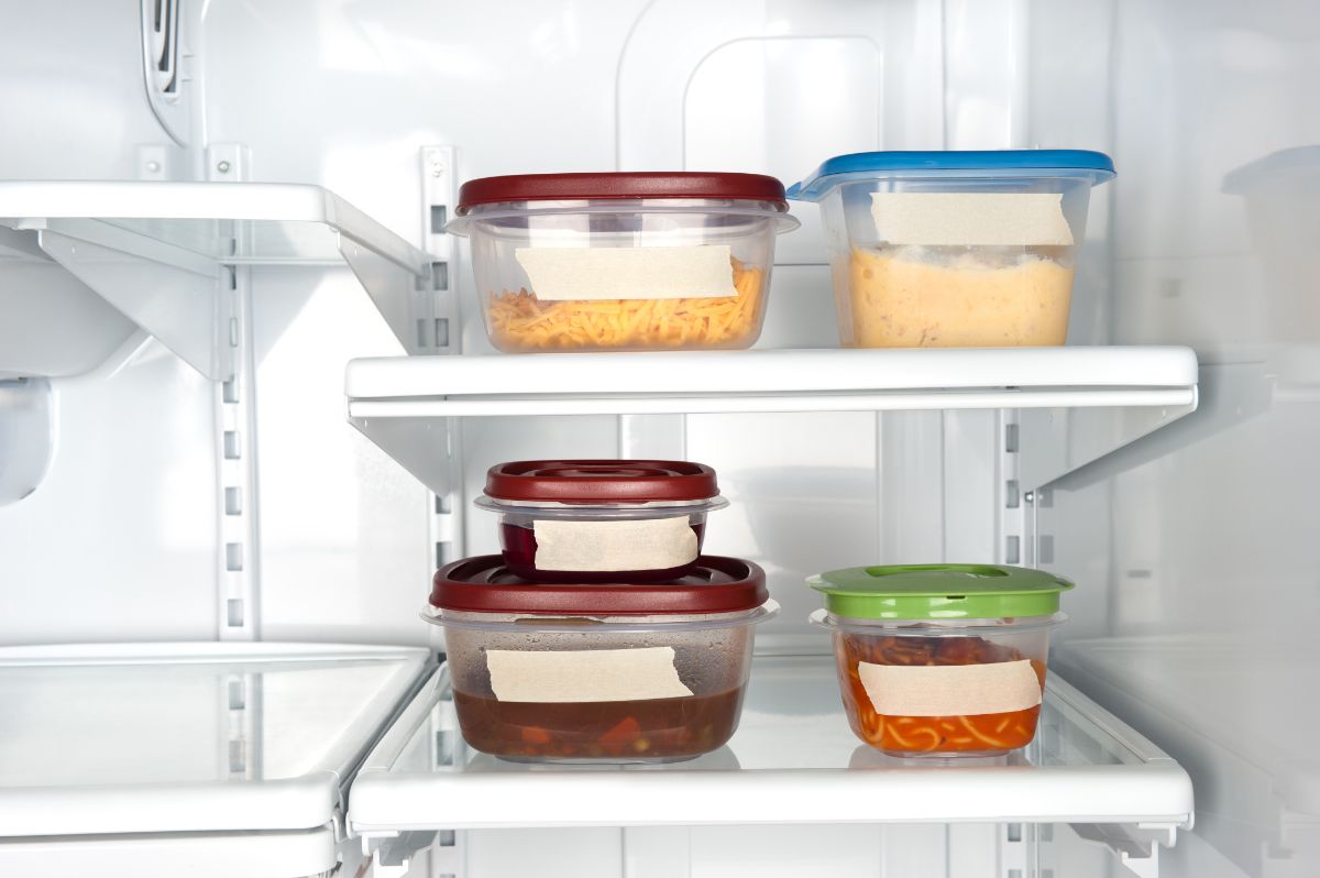 Plastic containers with leftovers in refrigerator.