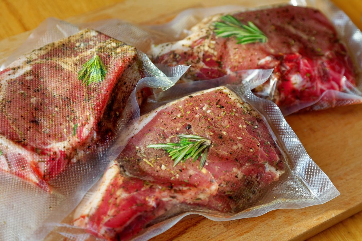 Fresh meat in vacuum sealed bags on table.