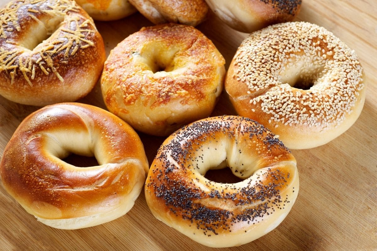 Fresh baked bagels on wooden table.