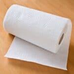 Roll of paper towels on brown table.