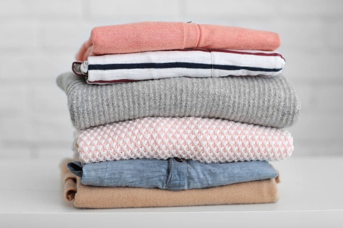 Pile of different types of folded clothes.