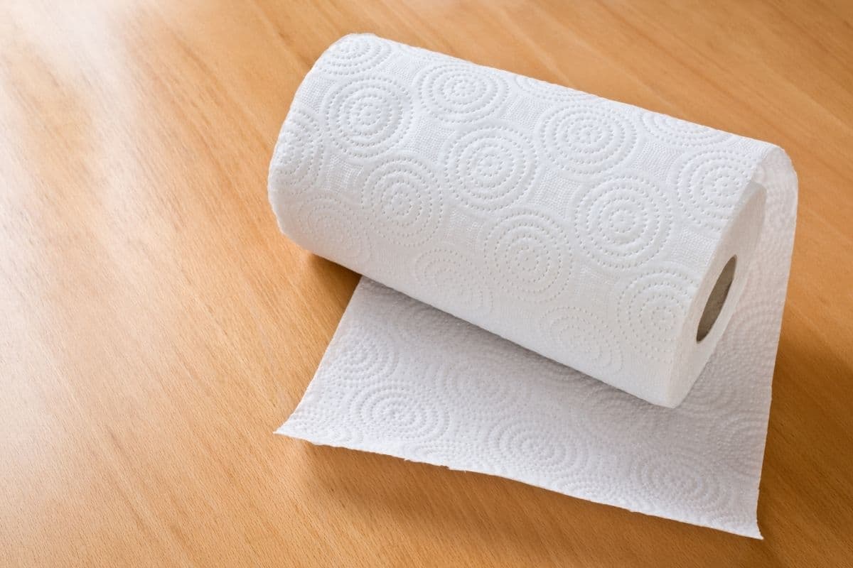Roll of paper towels on brown table.