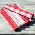 Rolled red-white cloth napkins on table
