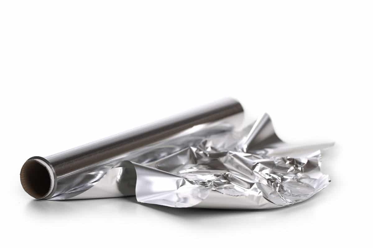 Roll of aluminium foil on white background