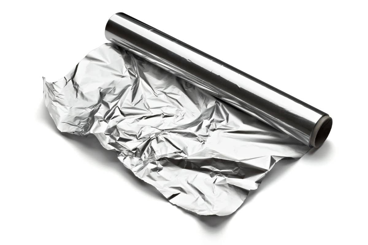 Roll of aluminium foil on white background