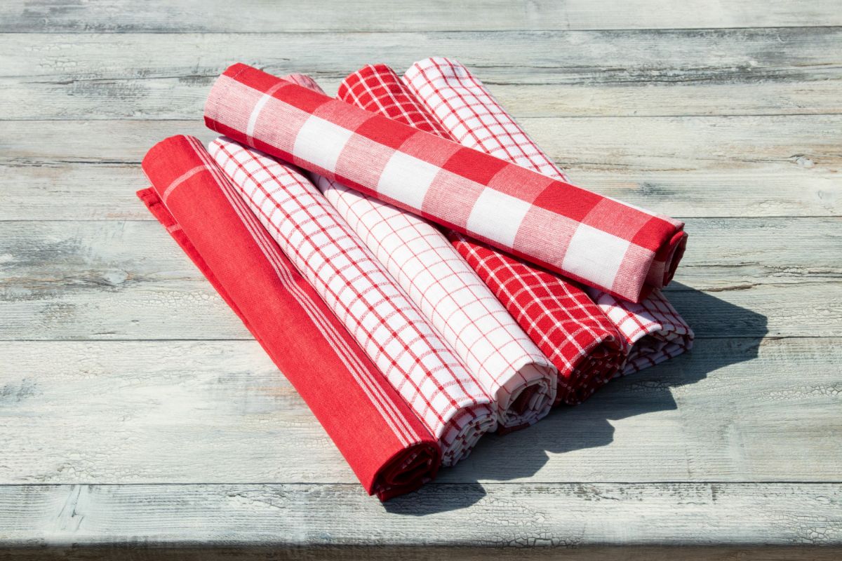 Rolled red-white cloth napkins on table