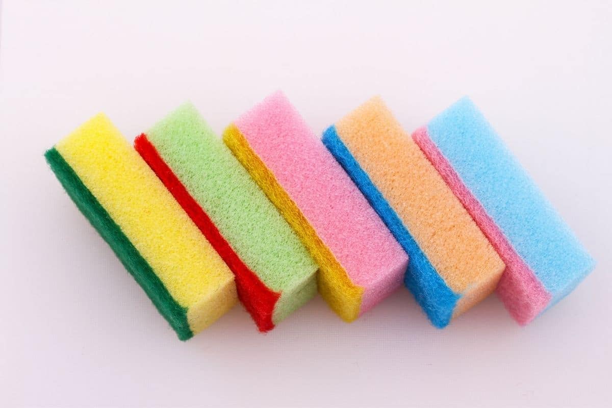 Bunch of colorful sponges on pink background