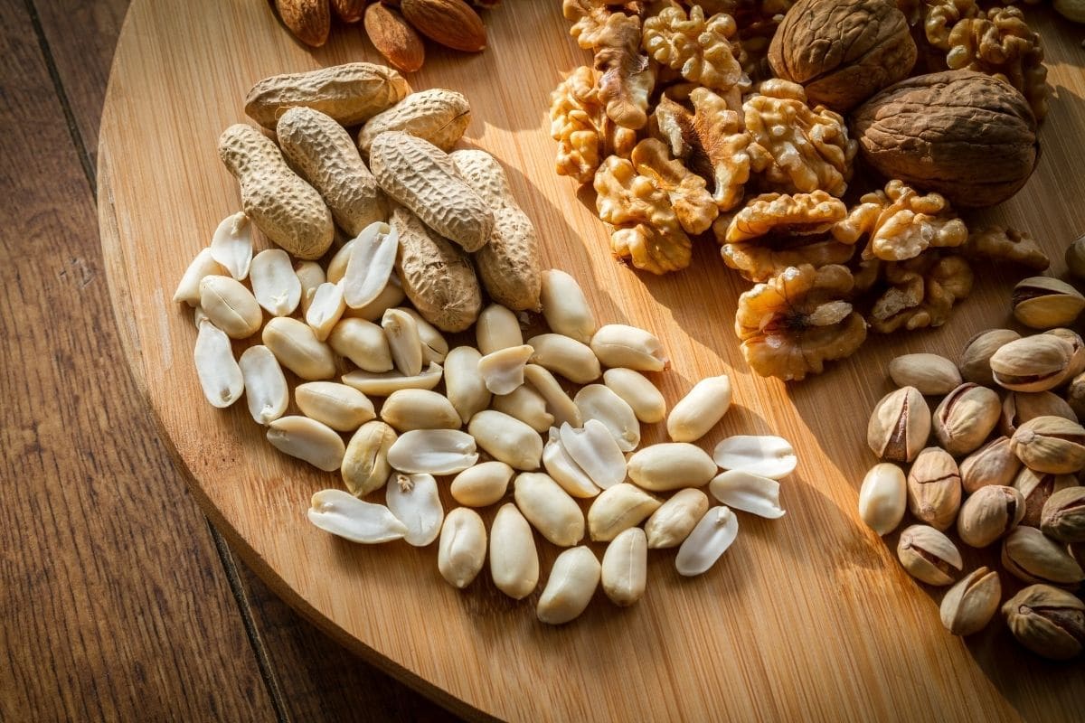 Different types of nuts on wooden board