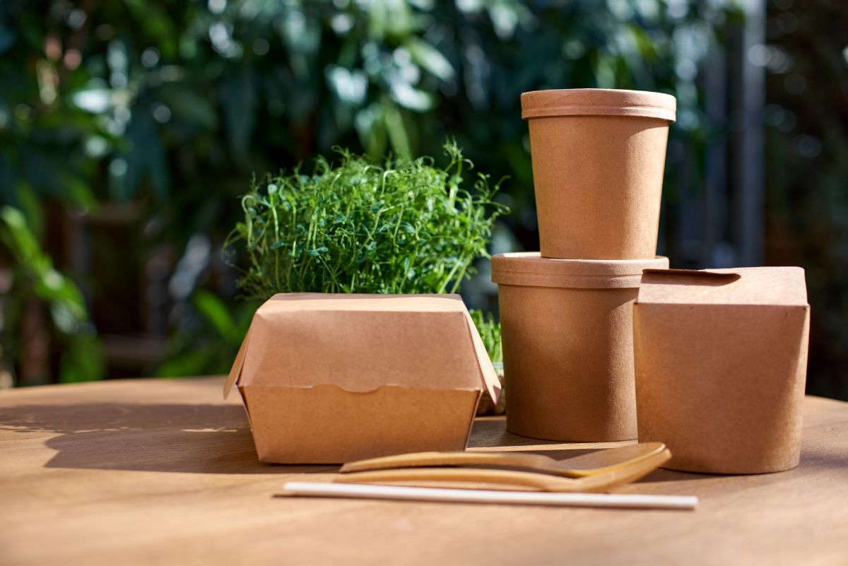 Different types of to-go papaer boxes on wooden table