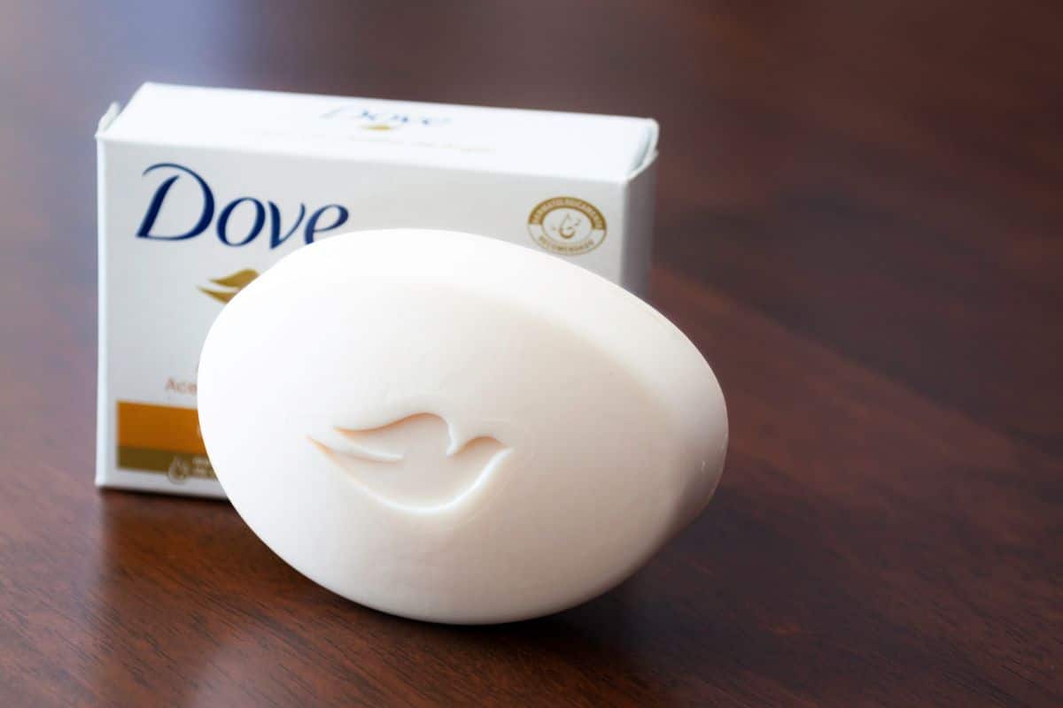 Block of dove soap with package on brown table