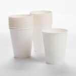 Piles of paper cups on white background