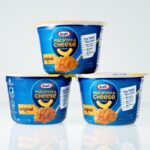 Three packages of krat mac and cheese on white background