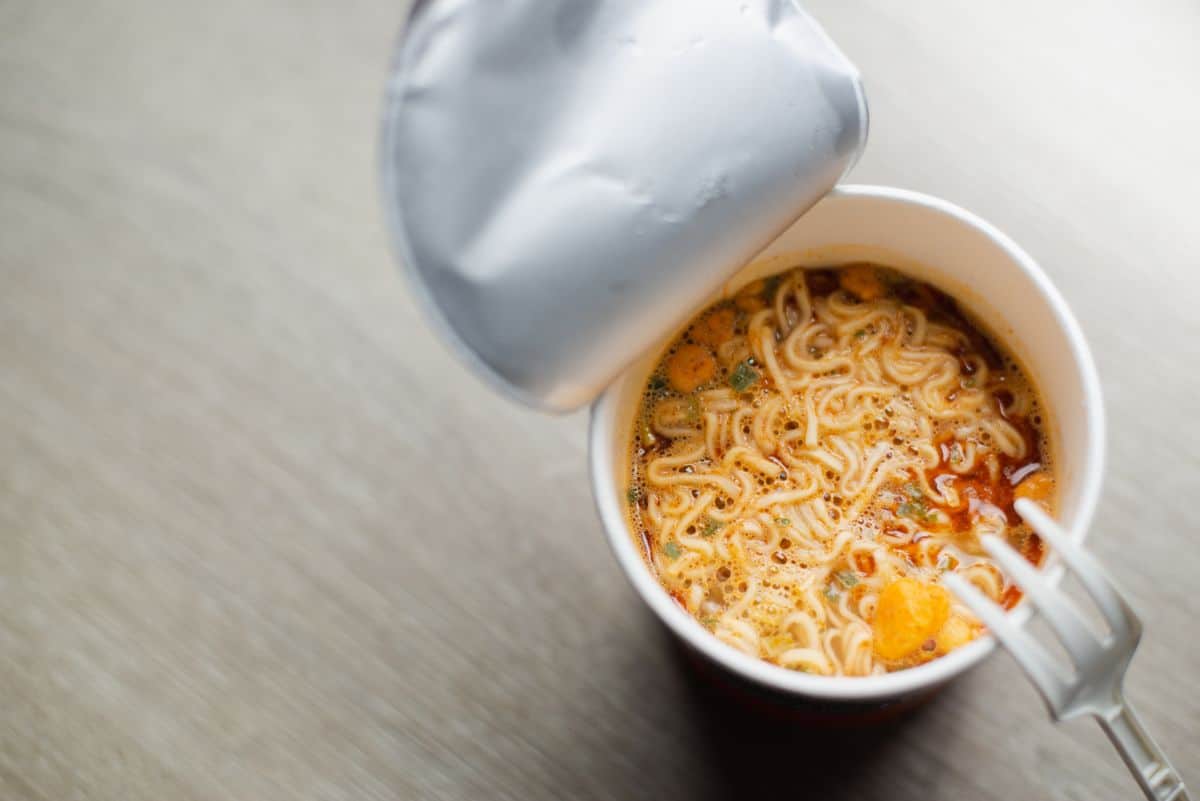 Nissin instant noodle cup top view on table with fork