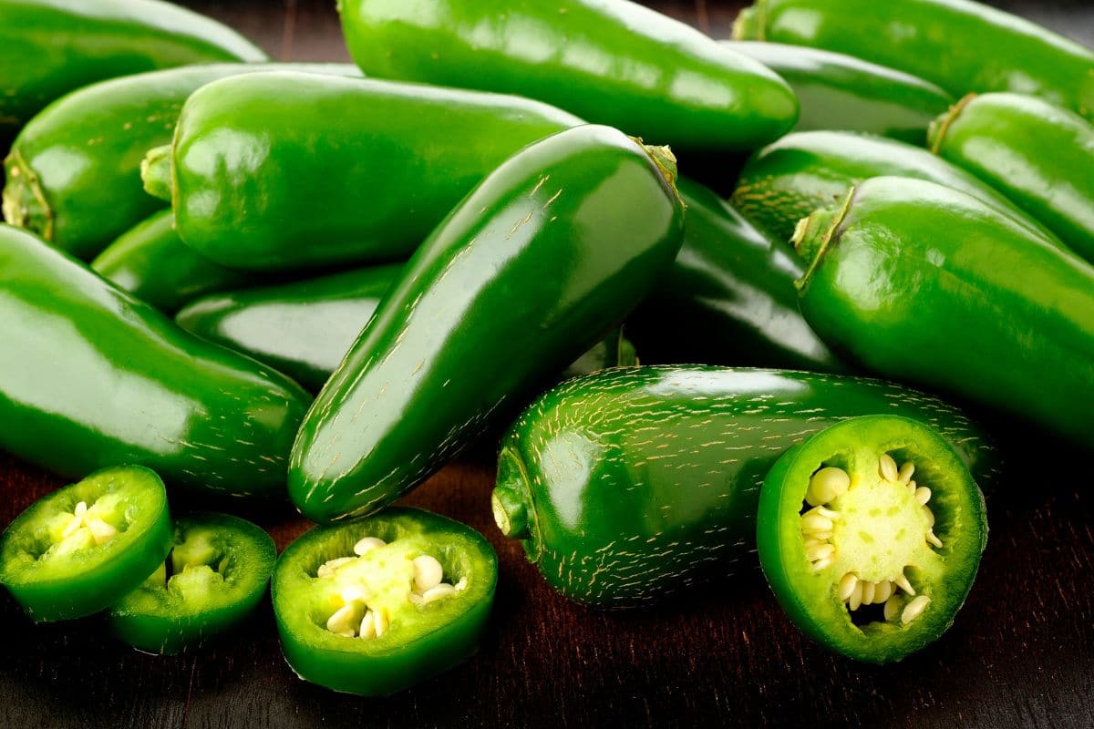 Green fresh jalapeno peppers on table