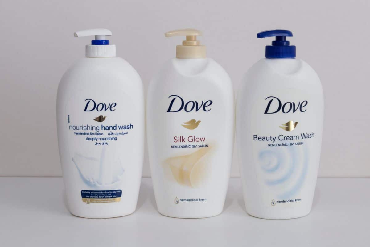 Three packages of liquid dove soap on white background