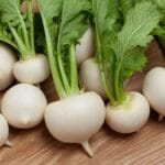 Bunch of white turnips on wooden table