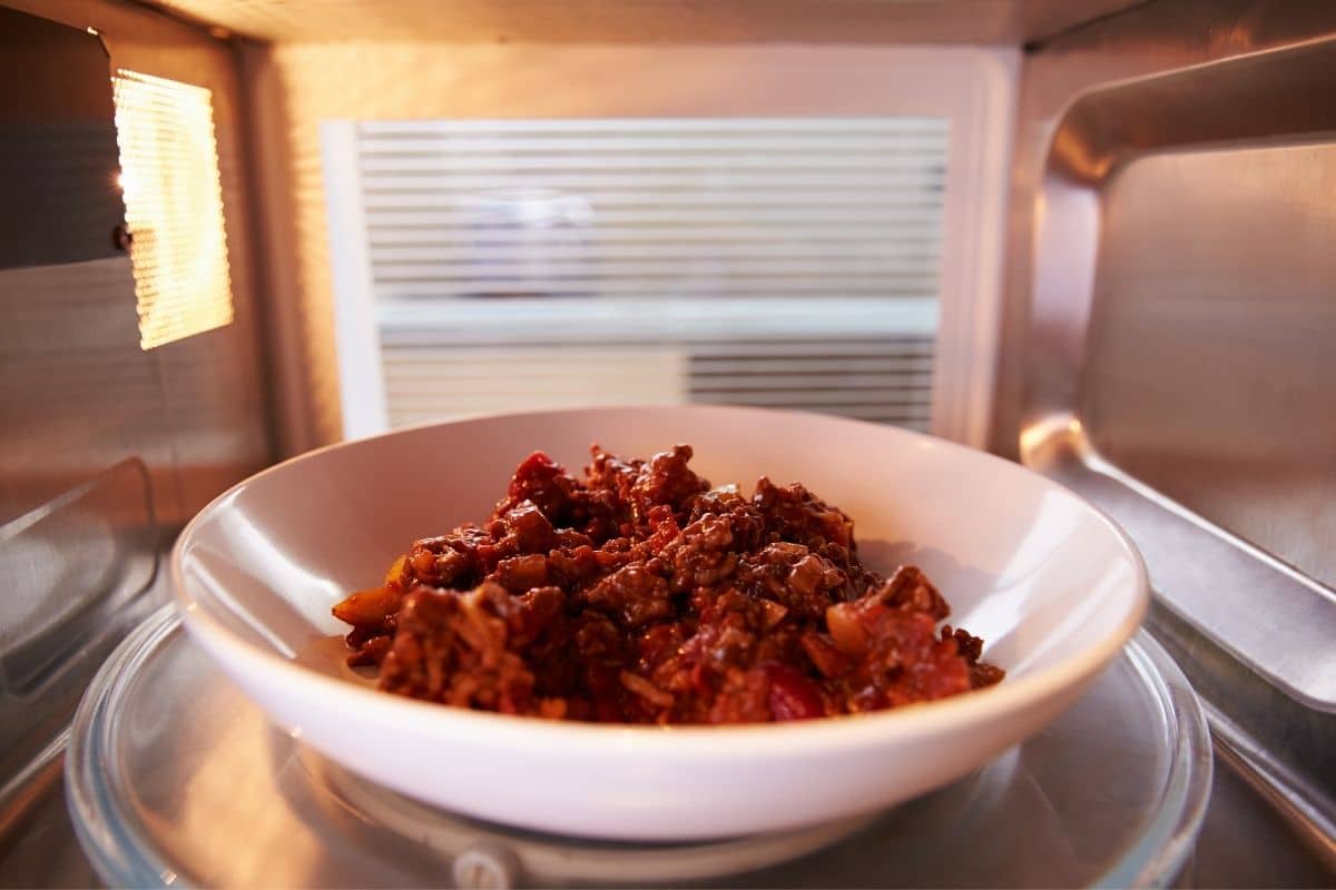 Beef on white plate in microwave