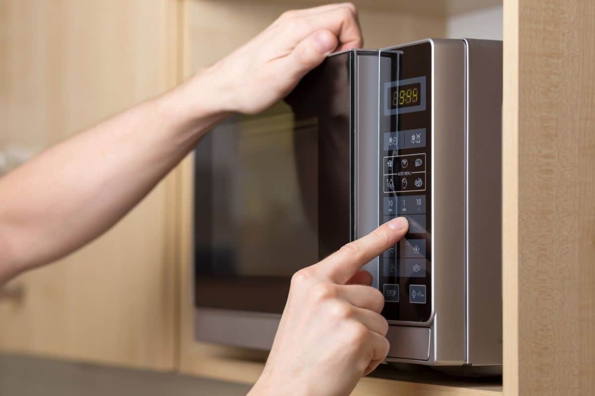 Hands setting up microwave