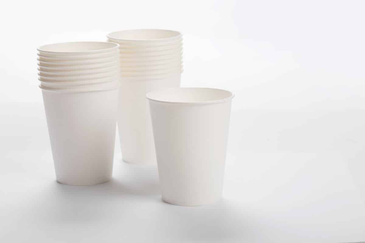 Piles of paper cups on white background