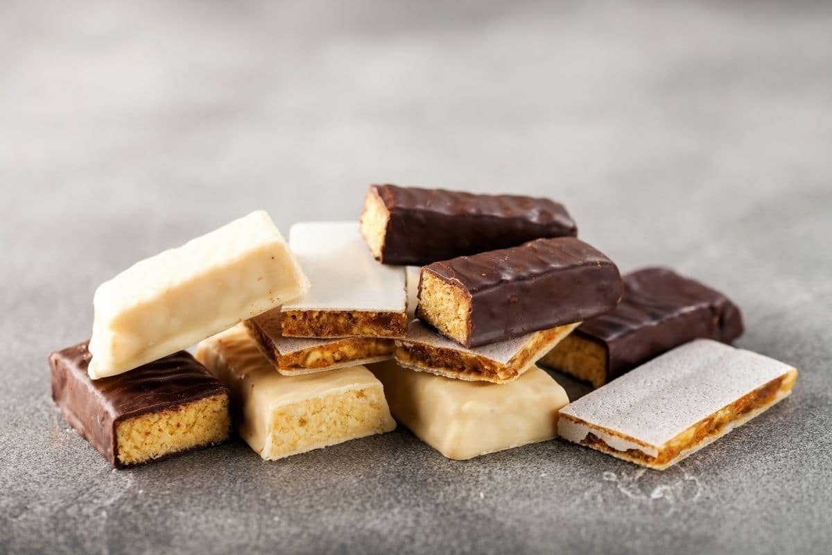 Different types of protein bars on gray table