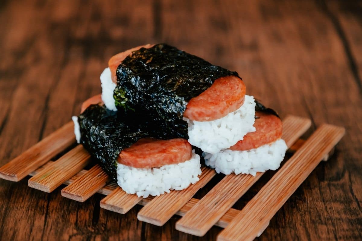 Spam and rice wraps on wooden rack