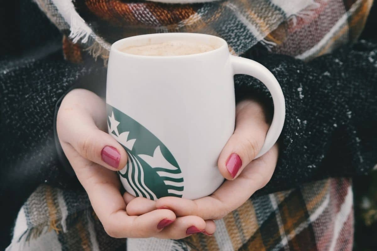 Woman holding starbucks ceramic mug