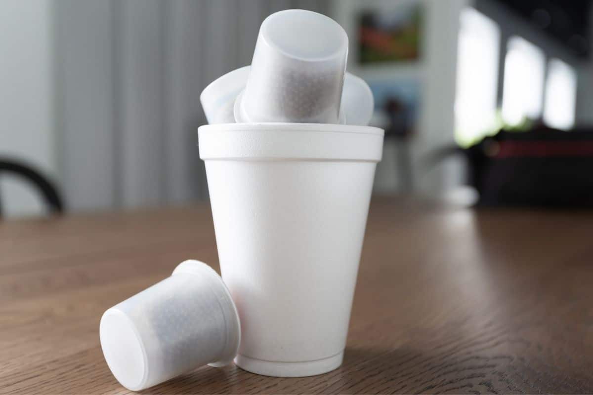 Big and small styrofoam cups on brown table