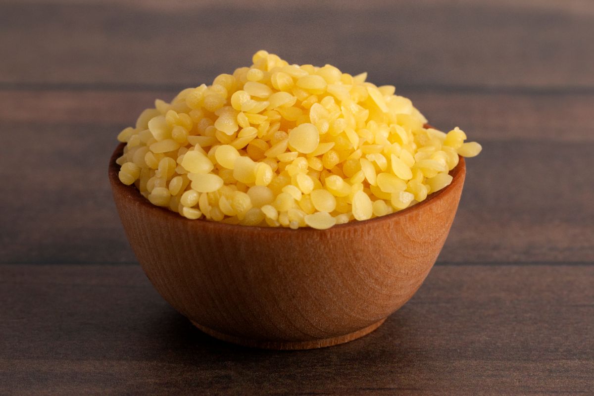 Wooden bowl of natural bee wax.