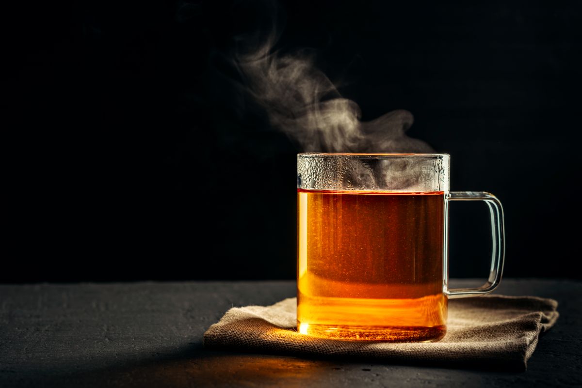 Cup of hot tea on a black background.