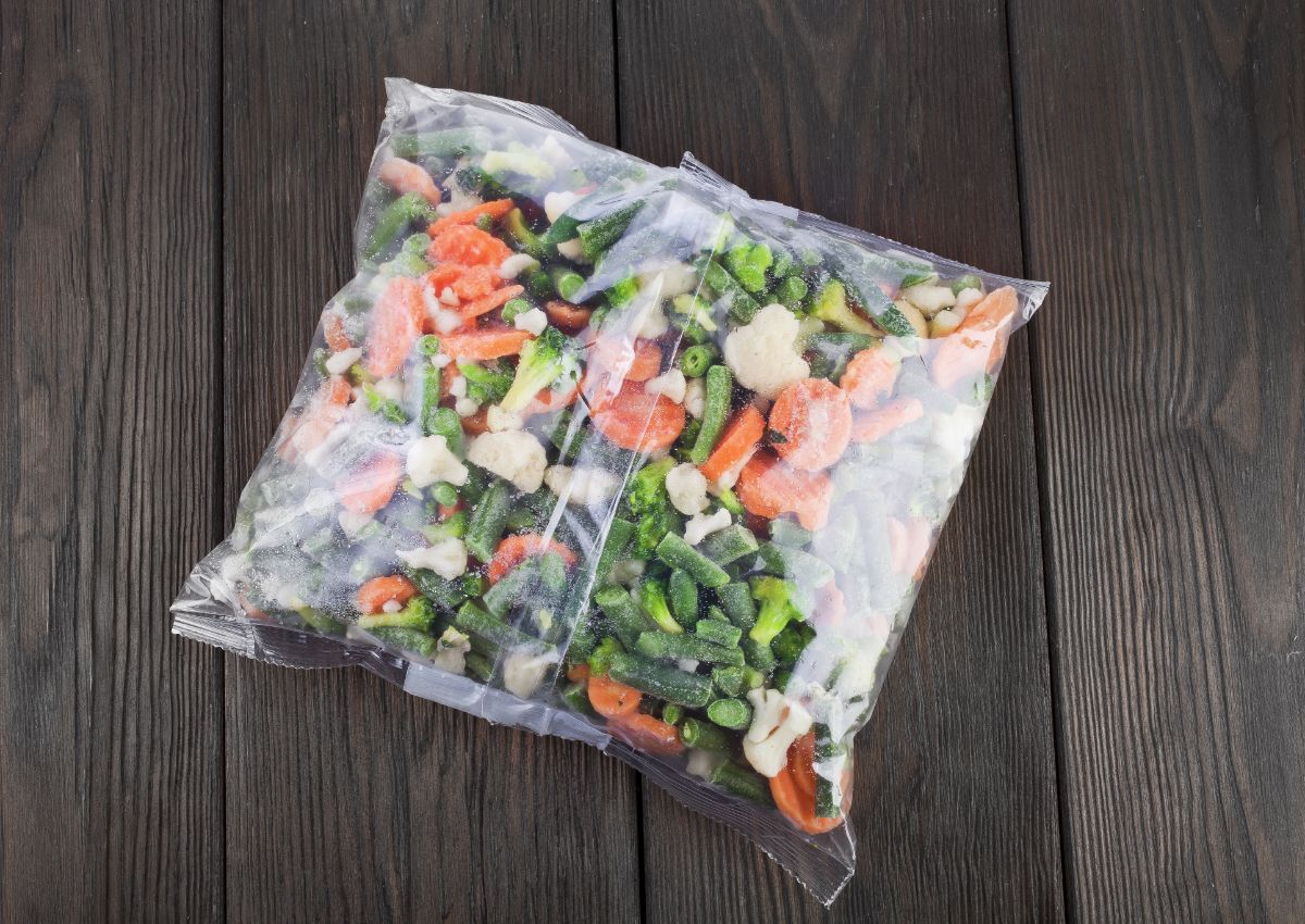 Bag of frozen vegetables on a wooden table.