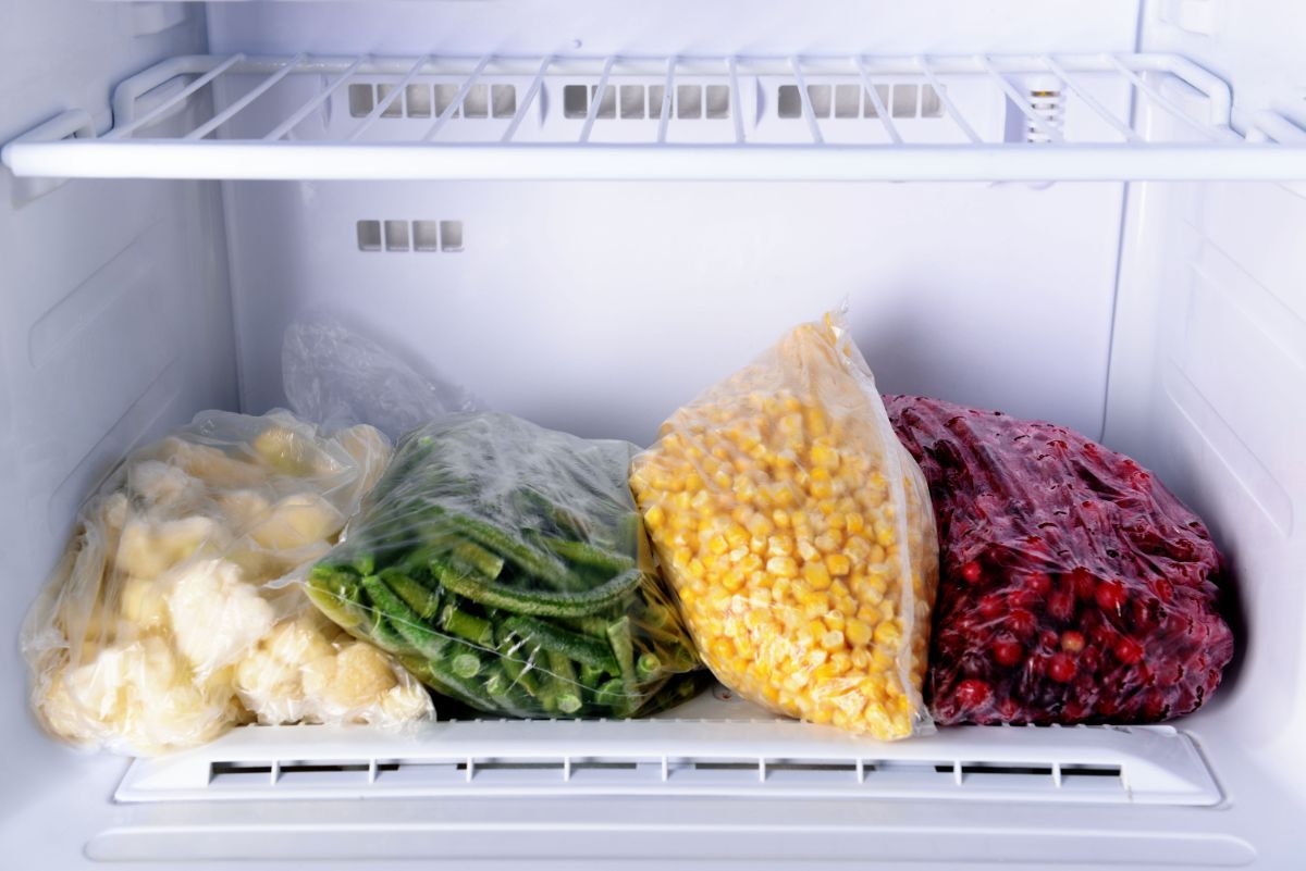 Bag of frozen vegetables in a fridge.
