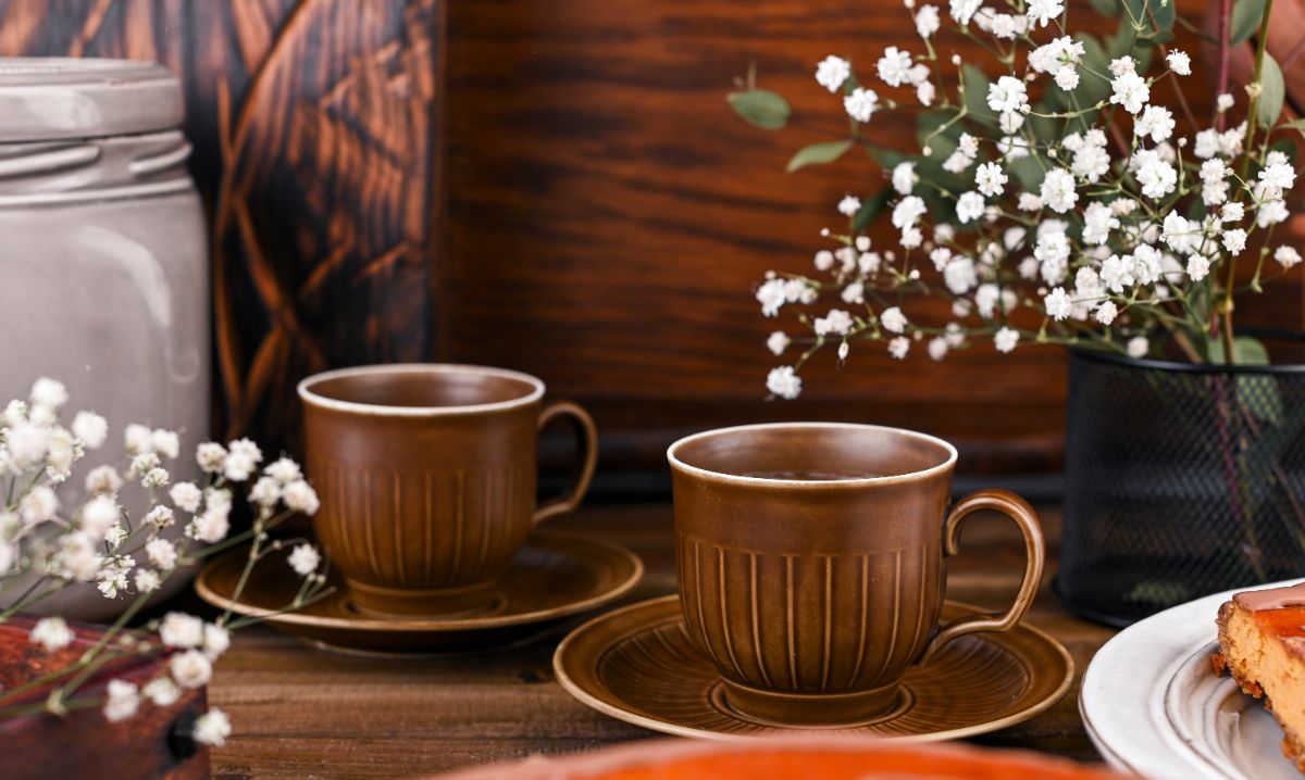 Two ironstone cups on a table.