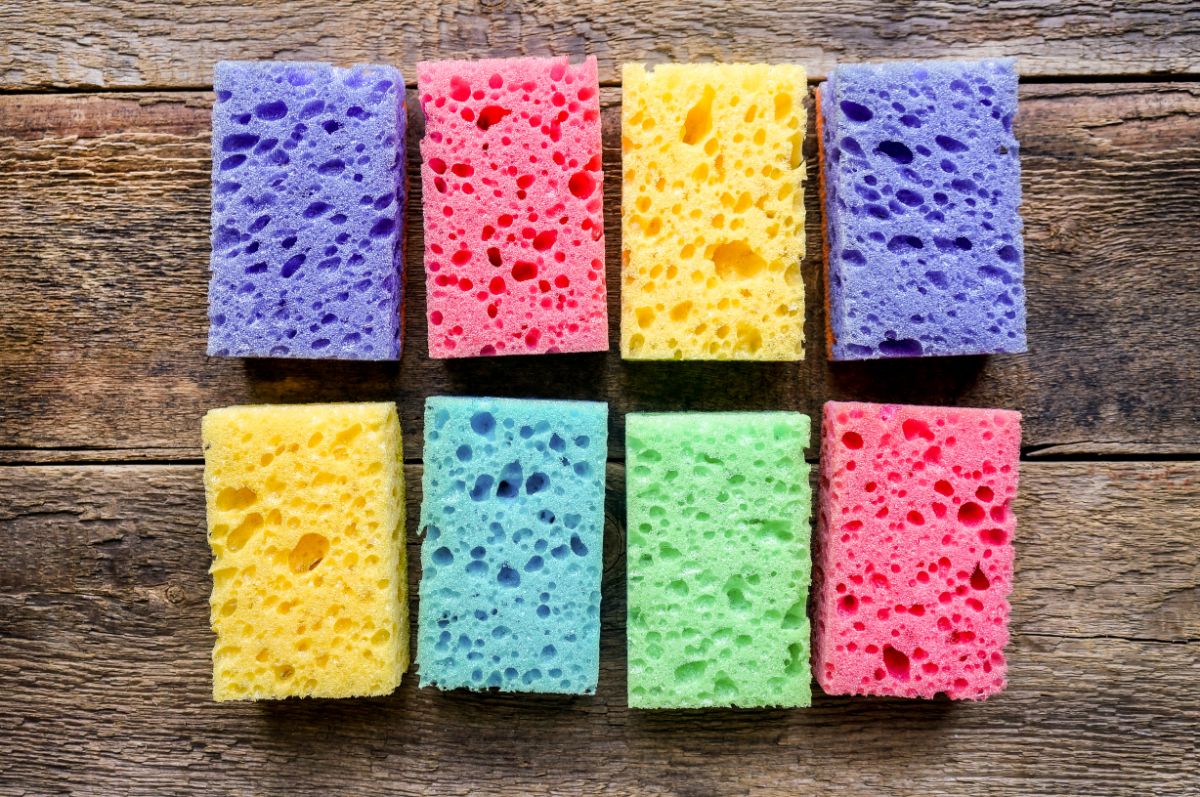 Bunch of colorful kitchen sponges on a table.