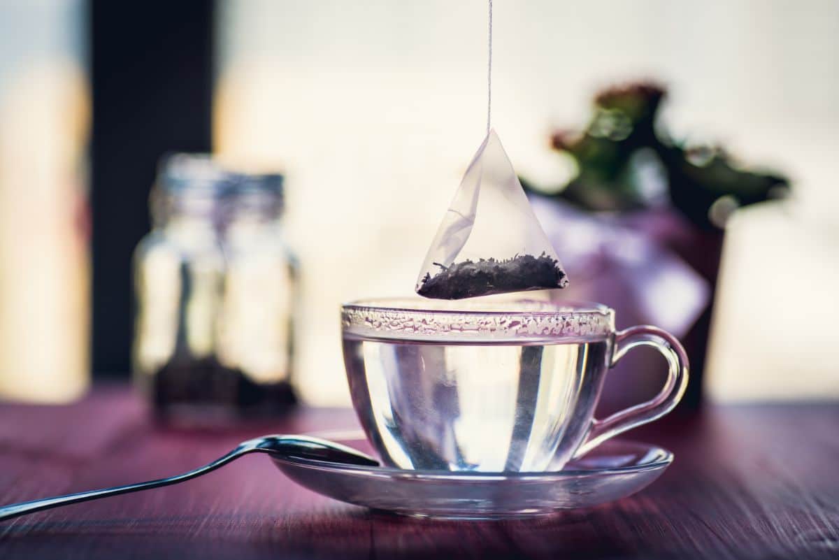 Tea bag over a cup of hot water.