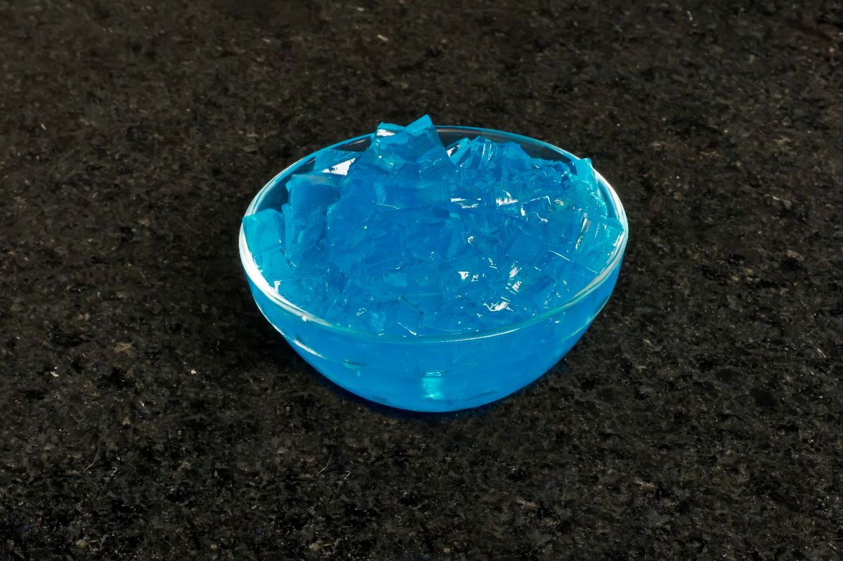 Bowl of blue jelly dessert on a table.