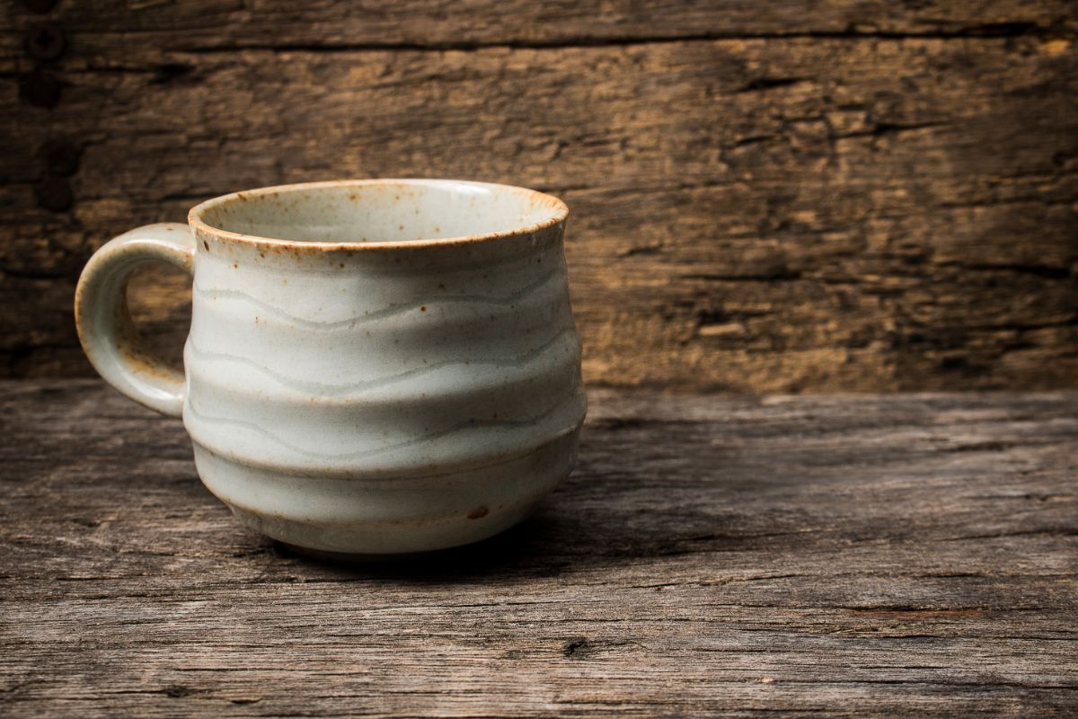 Handmade ceramic mug on  a wooden table.