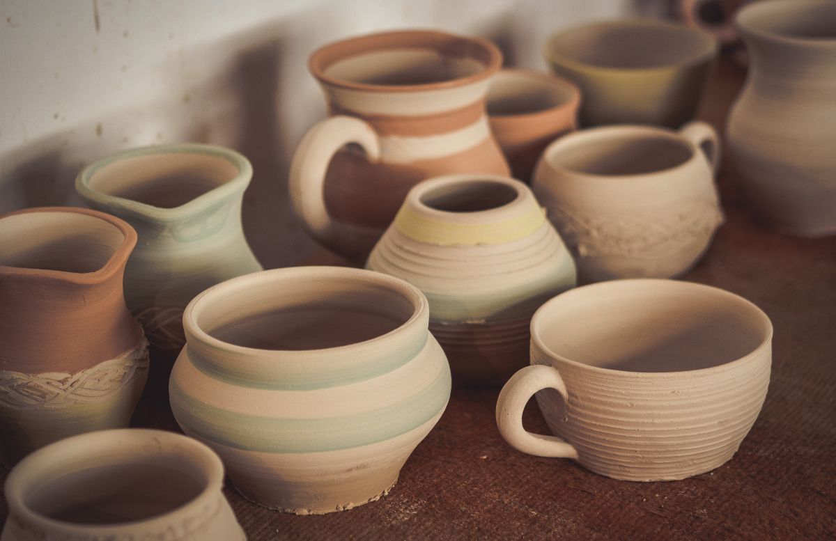 DIfferent varieites of clay pottery on a table.