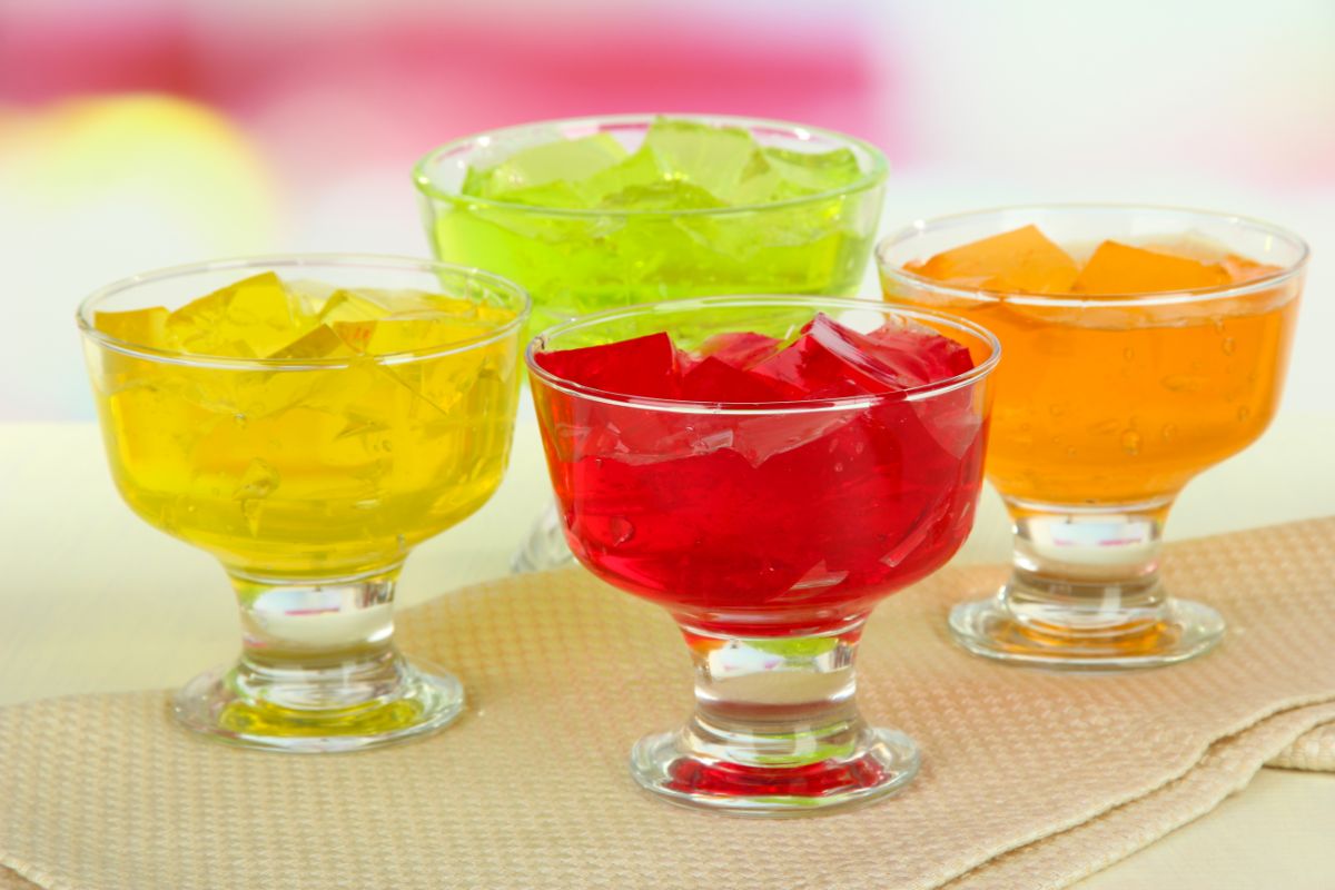 Bowls full of jello cubes on a table.