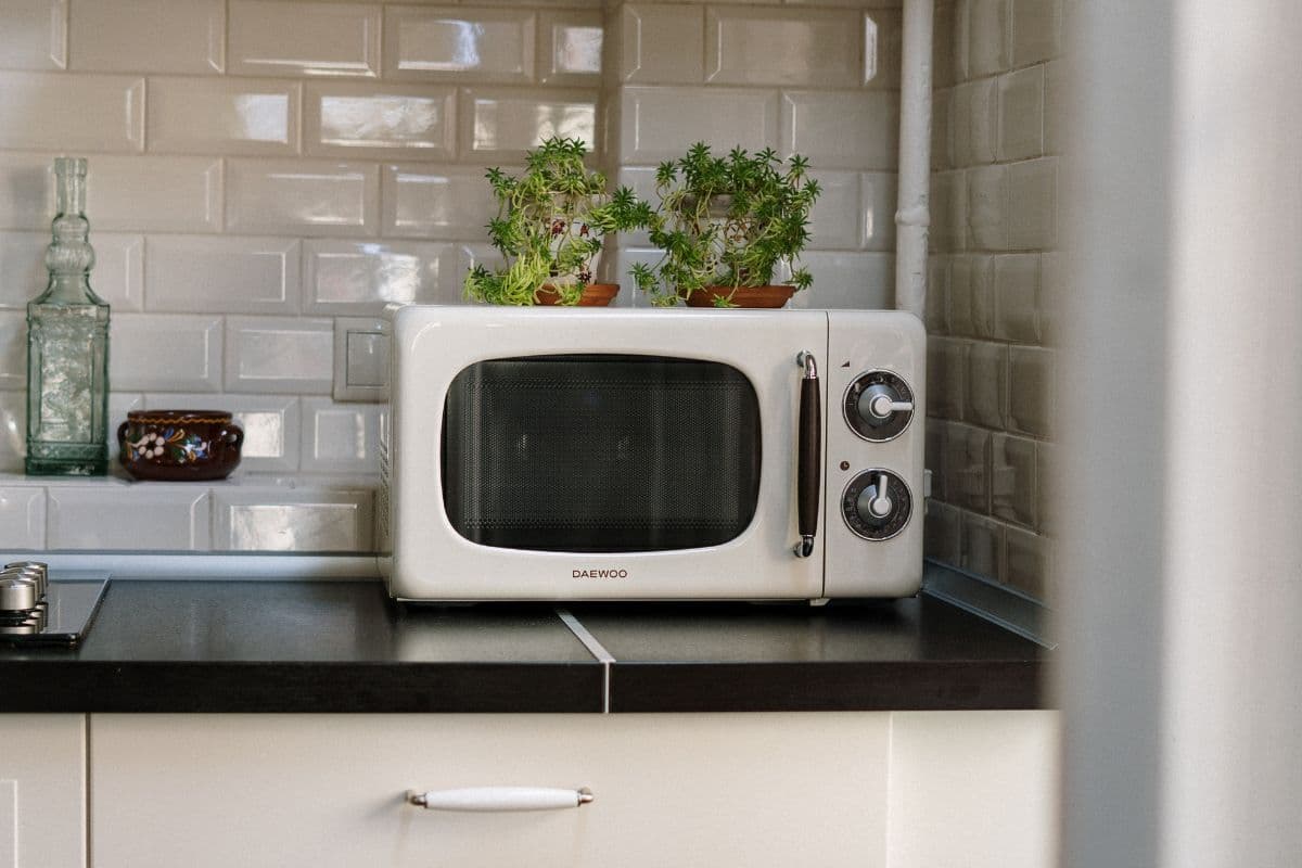 A white microwave on a kitchen counter.