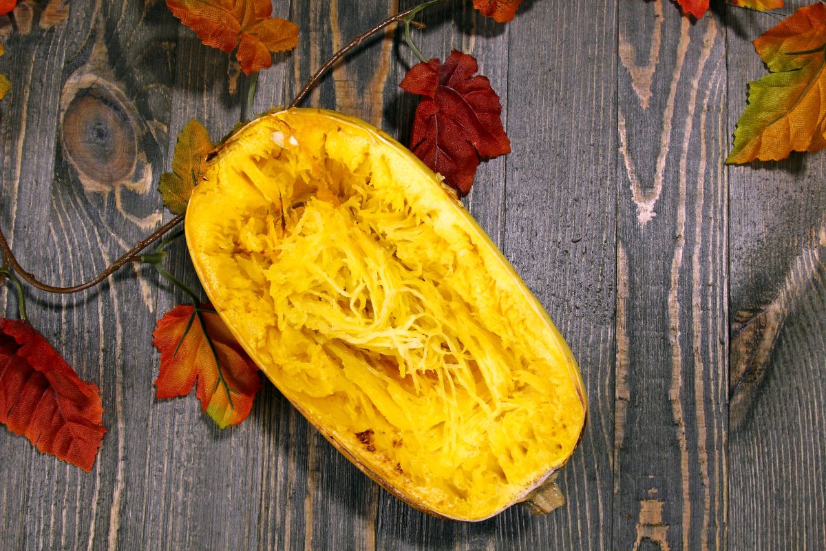 Half of spaghetti squash on a wooden table.