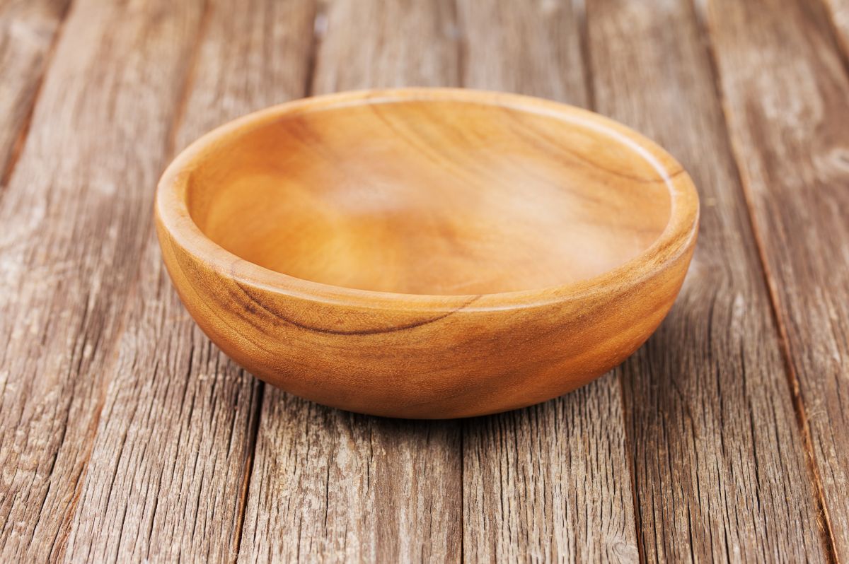 A wooden bowl on a wooden table.