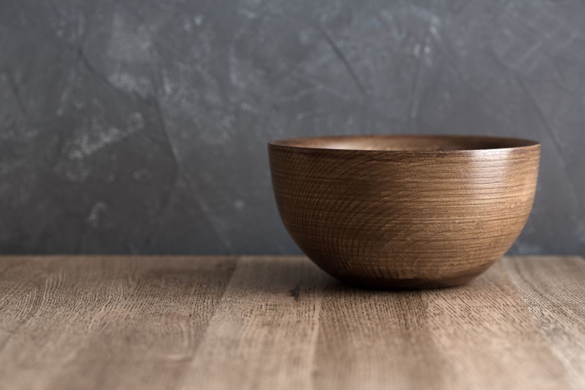 A wooden bowl on a wooden table.